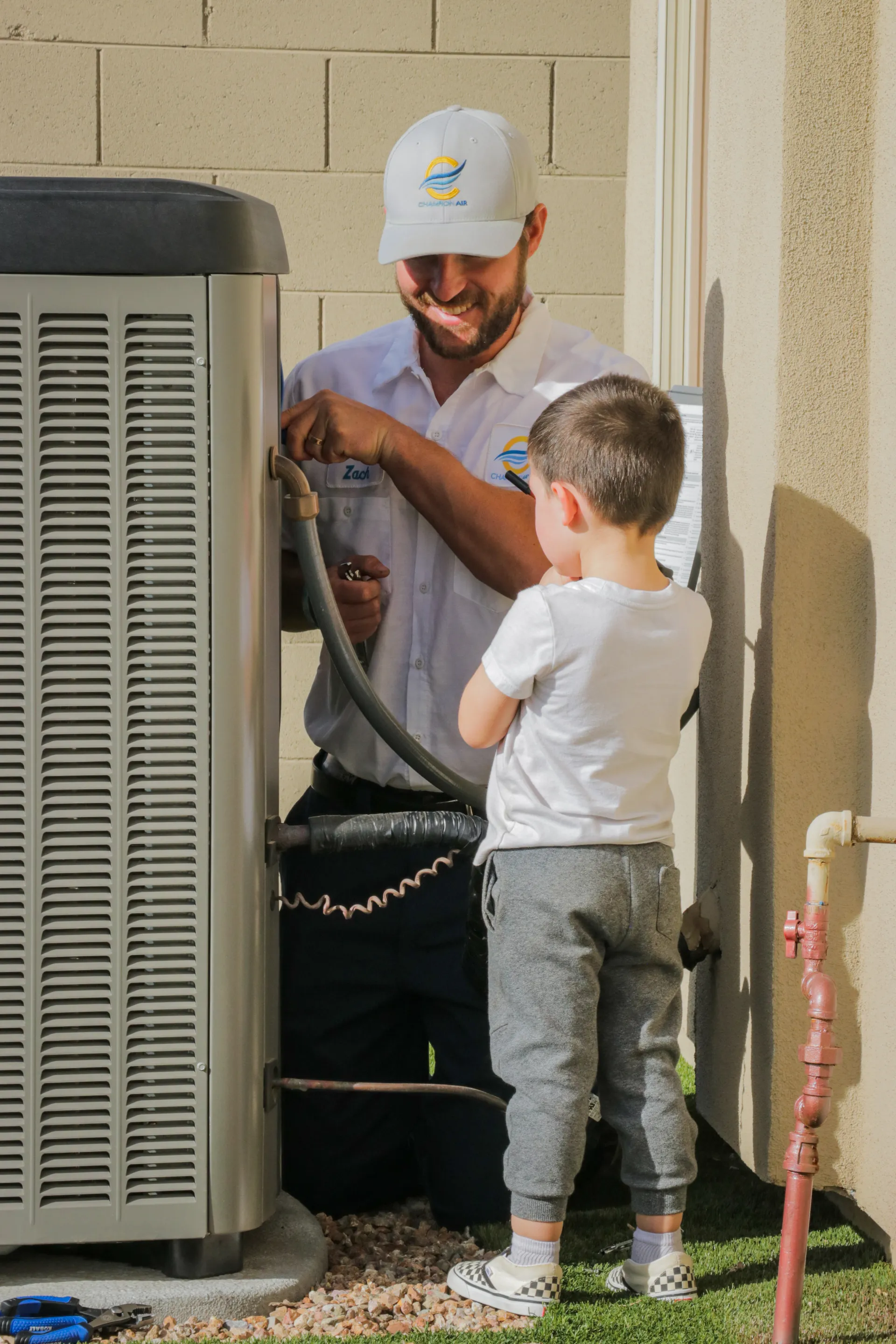 Champion Air technician performing HVAC maintenance