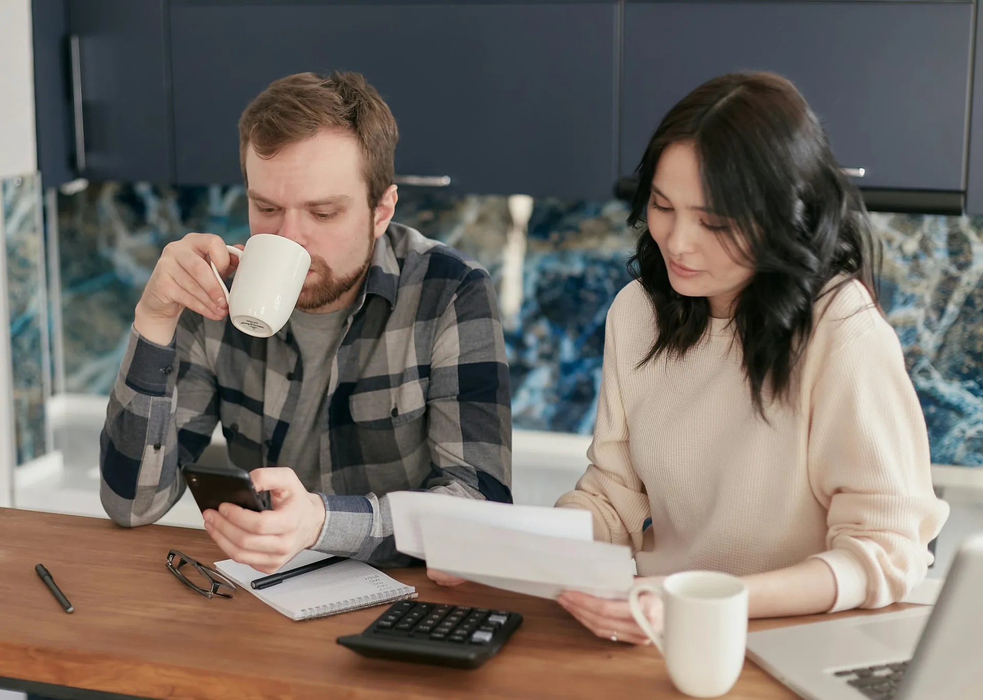 Homeowner reviewing energy bills and considering the cost of HVAC repairs - when to repair vs replace your ac system Homeowner reviewing energy bills and considering the cost of HVAC repairs - when to repair vs replace your ac system