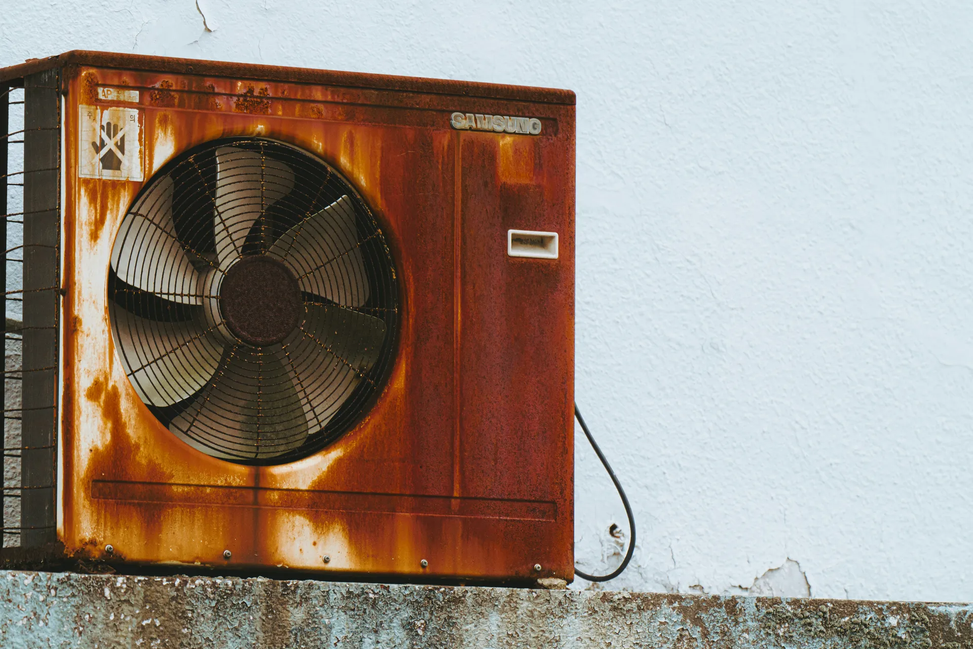 an aging weathered outdoor condenser unit in a desert yard - what to expect during ac replacement in arizona an aging weathered outdoor condenser unit in a desert yard - what to expect during ac replacement in arizona
