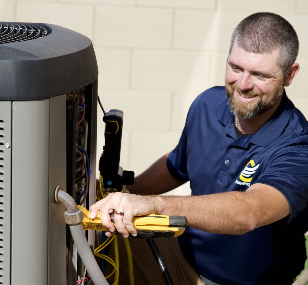 Champion Air technician inspecting an air conditioning system in Scottsdale, AZ