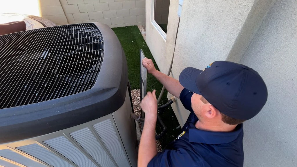 Champion Air technician inspecting an air conditioning system in Scottsdale, AZ