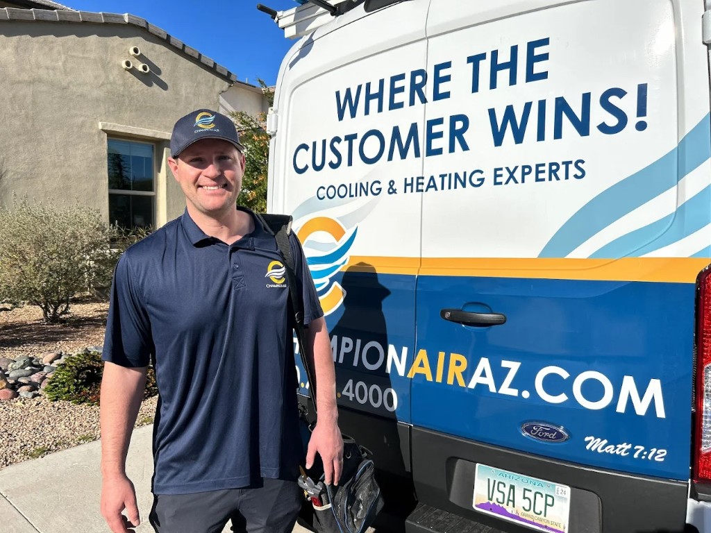 Champion Air technician inspecting an air conditioning system in Scottsdale, AZ
